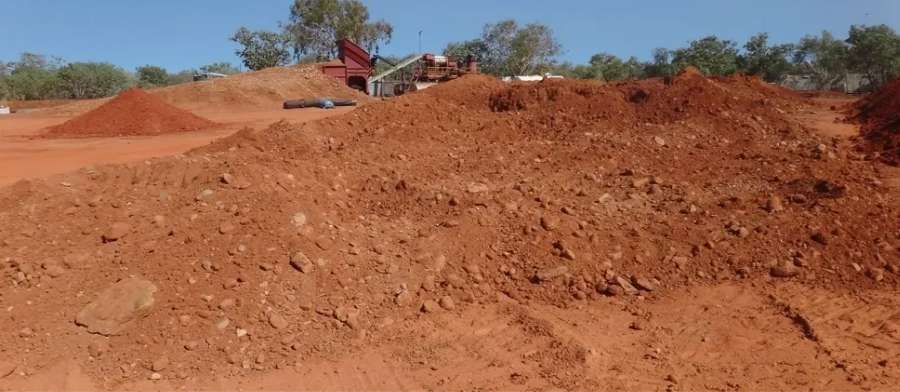 Rain soaked A layer gravels are spread in the sun to dry before processing.