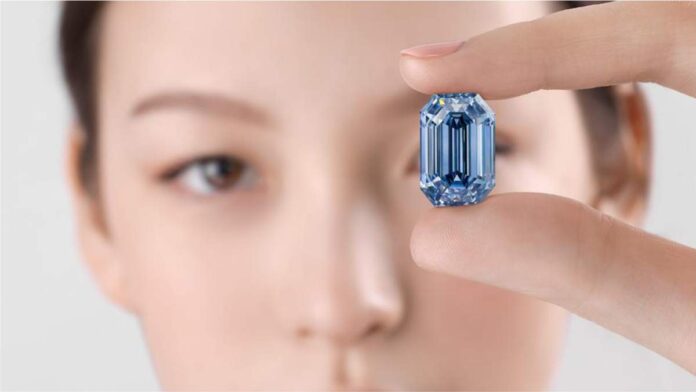 Model holding the 15.1-carat De Beers Blue diamond